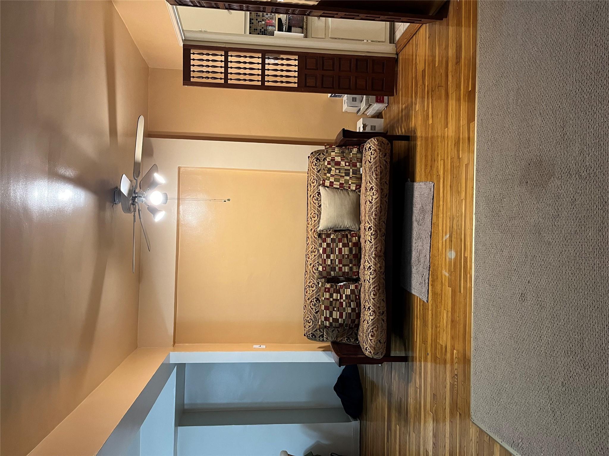 33-24 Junction Boulevard, Unit 3M Queens, NY 11372 - Photo 3 of 15 a living room with couch and a rug