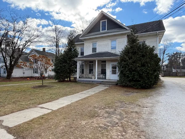 a front view of a house with a garden