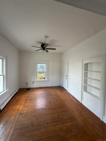 wooden floor in an empty room with a window