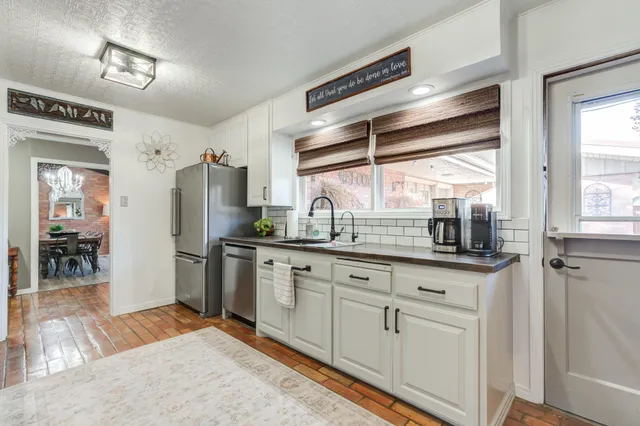 a kitchen with granite countertop a sink and cabinets