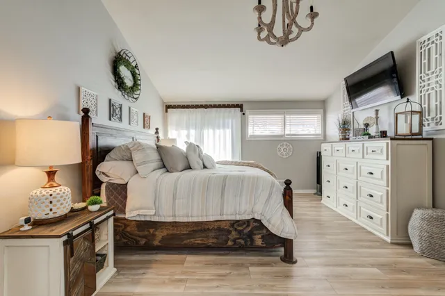 a bedroom with bed and wooden floor