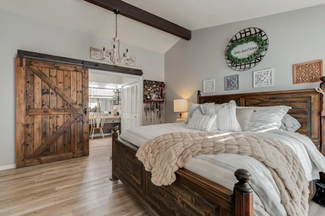 a kitchen with kitchen island a dining table chairs cabinets and stainless steel appliances