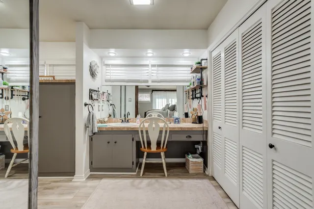 a view of hallway with wooden floor and furniture