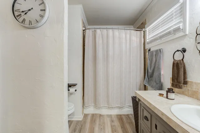 a bathroom with a glass shower door and a sink