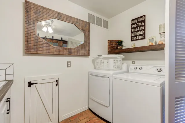 a view of a kitchen with fridge and wooden floor