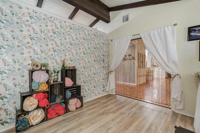 a view of a workspace with furniture and a window