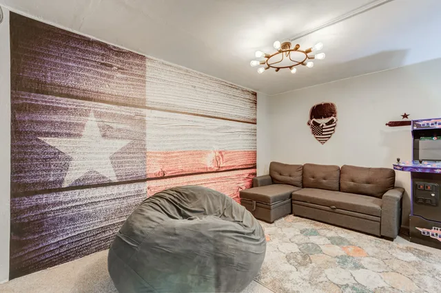 a living room with furniture and painting on the wall