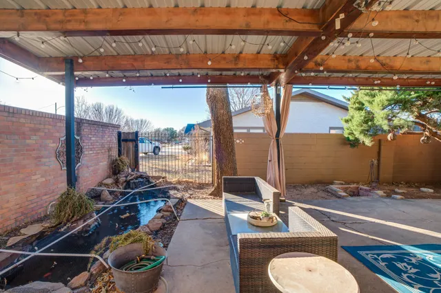 a view of a patio with table and chairs and potted plants