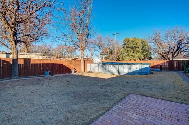 a view of a house with wooden fence