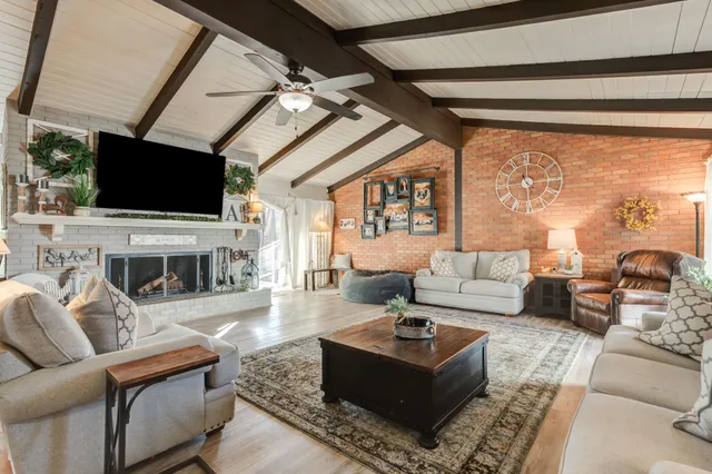 a living room with fireplace furniture and a flat screen tv
