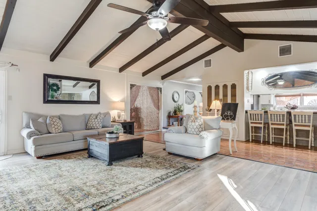 a large kitchen with granite countertop cabinets a sink a window and stainless steel appliances