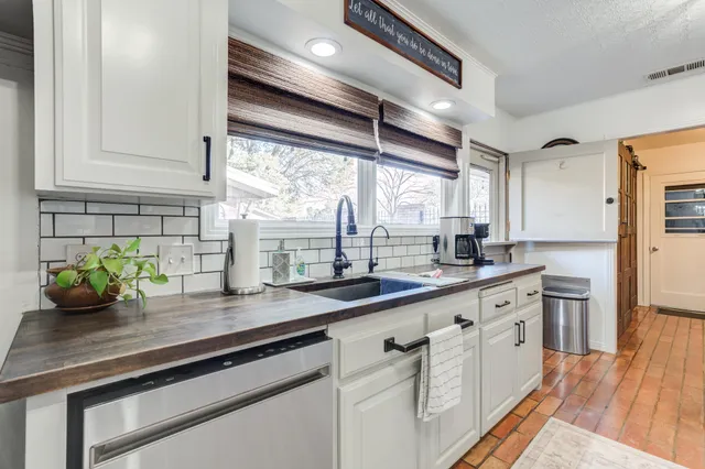 a kitchen with cabinets and window