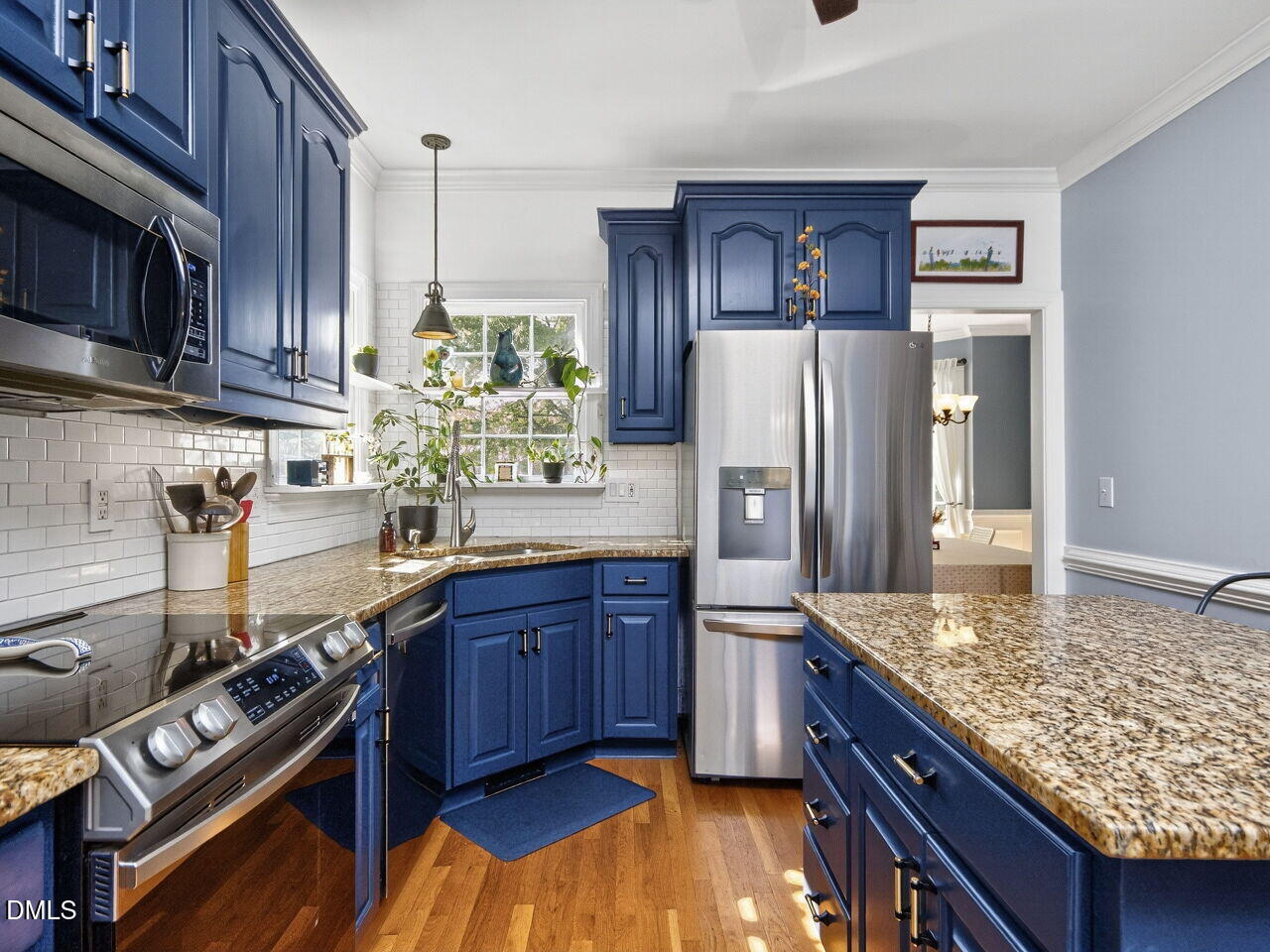 6736 Hammersmith Drive Raleigh, NC 27613 - Photo 11 of 42 a kitchen with stainless steel appliances granite countertop a stove refrigerator and cabinets
