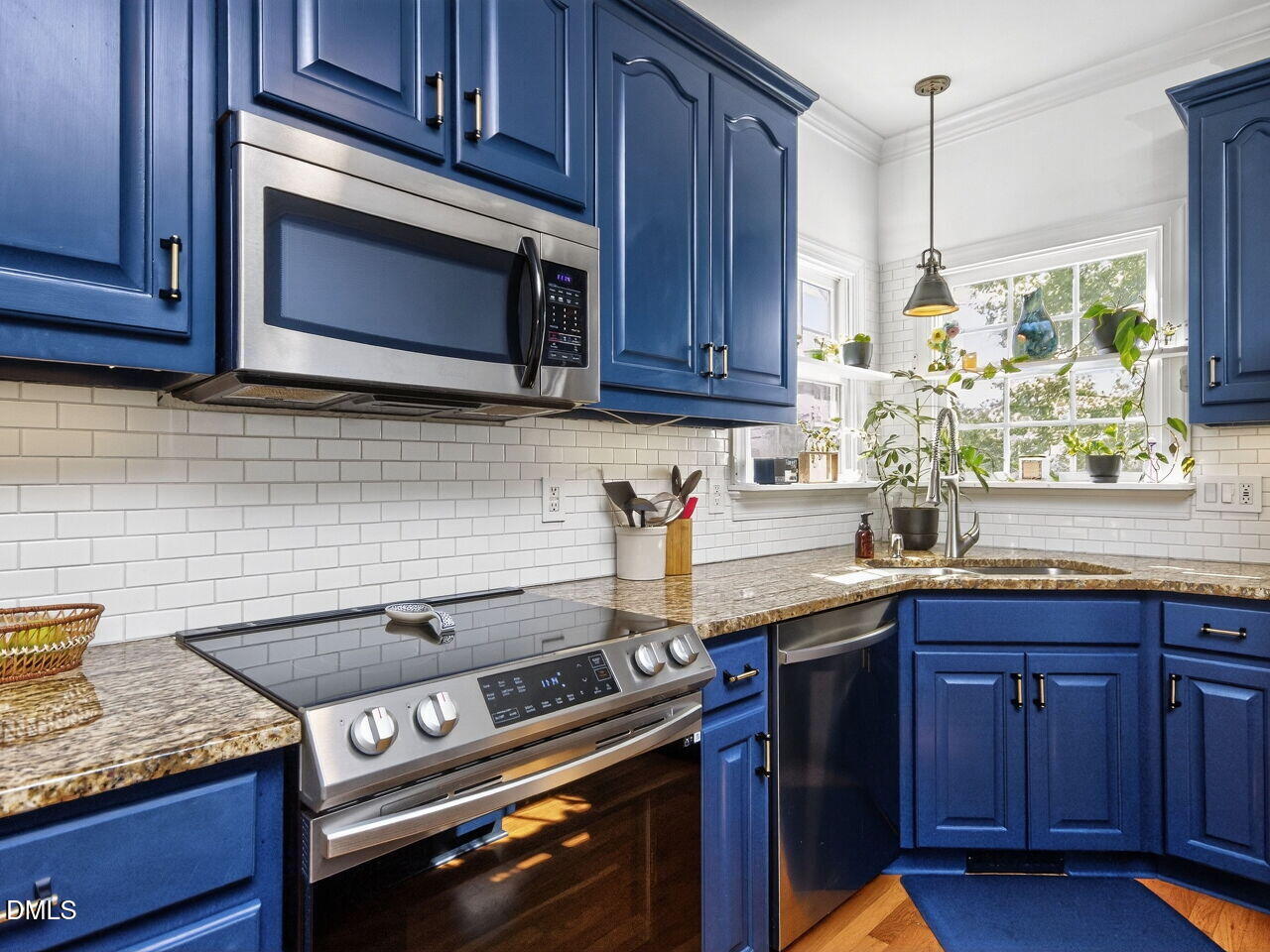 6736 Hammersmith Drive Raleigh, NC 27613 - Photo 12 of 42 a kitchen with granite countertop cabinets stove top oven and microwave