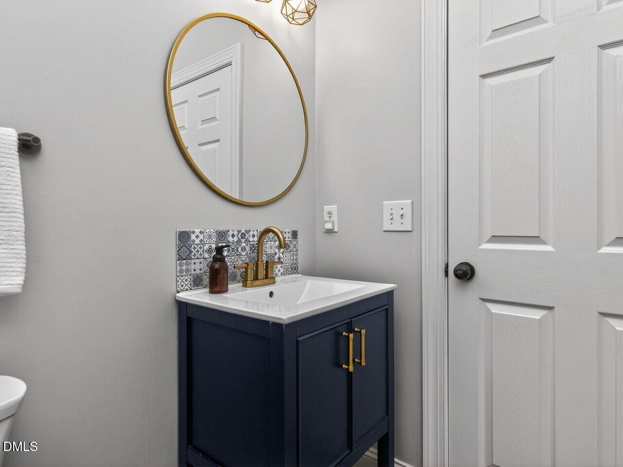 6736 Hammersmith Drive Raleigh, NC 27613 - Photo 17 of 42 a bathroom with a sink and a mirror