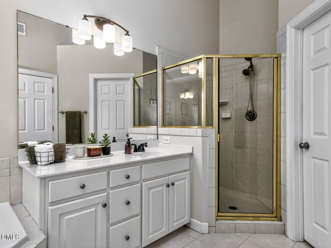 6736 Hammersmith Drive Raleigh, NC 27613 - Photo 21 of 42 a bathroom with a double vanity sink mirror and shower