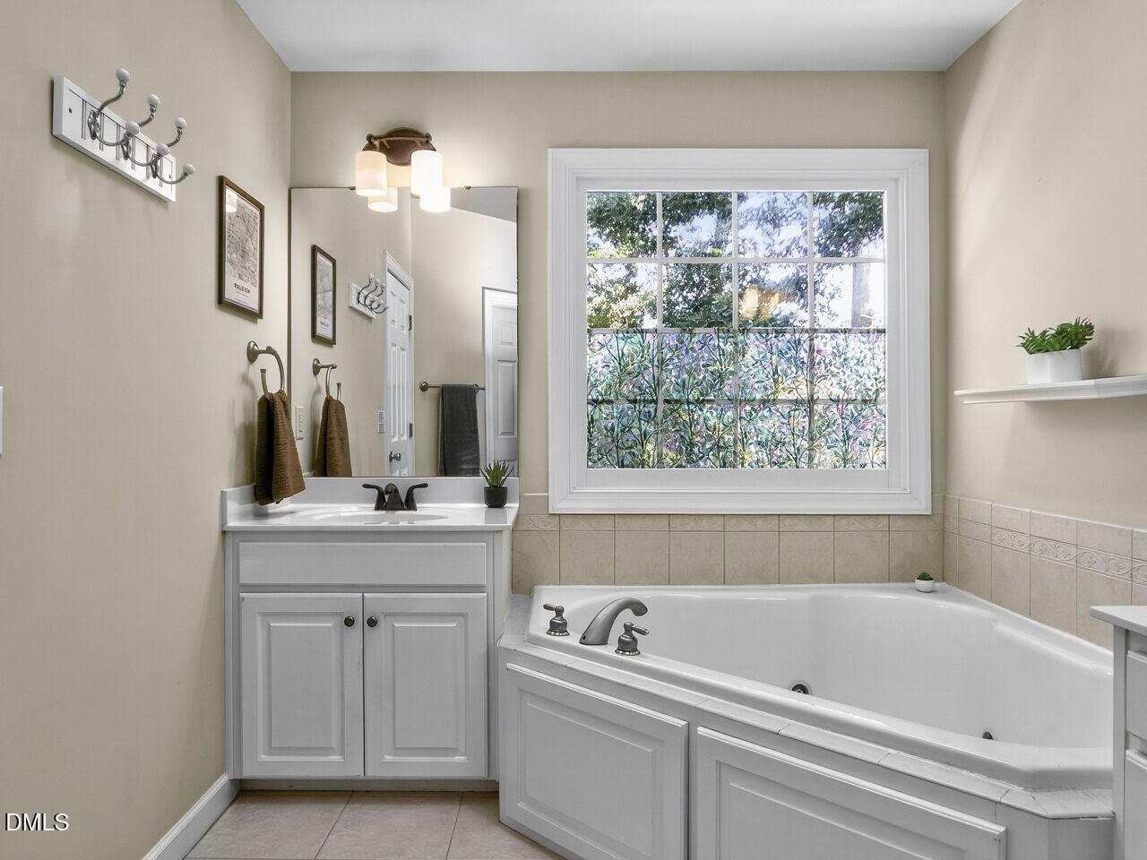 6736 Hammersmith Drive Raleigh, NC 27613 - Photo 22 of 42 a bathroom with a bathtub a sink and a window