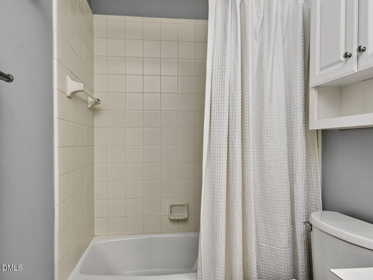 6736 Hammersmith Drive Raleigh, NC 27613 - Photo 29 of 42 a bathroom with a shower curtain and sink