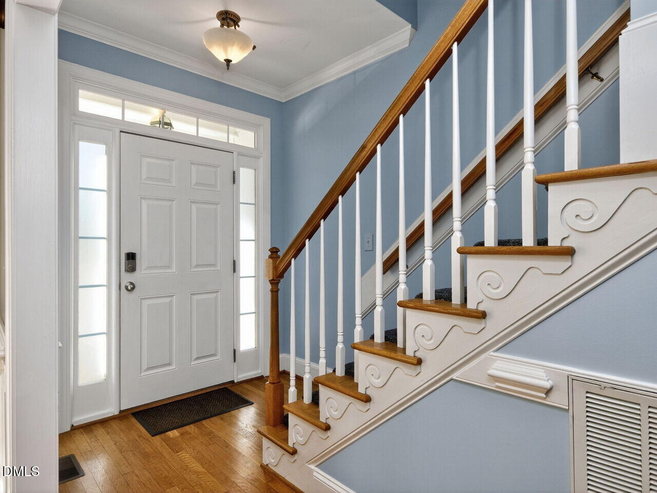 6736 Hammersmith Drive Raleigh, NC 27613 - Photo 4 of 42 a view of entryway with wooden floor and stairs
