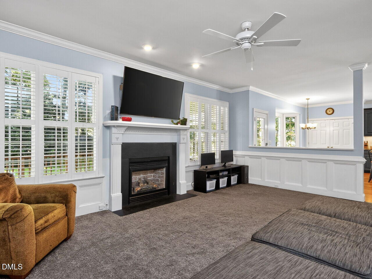 6736 Hammersmith Drive Raleigh, NC 27613 - Photo 8 of 42 a living room with furniture a fireplace and a flat screen tv