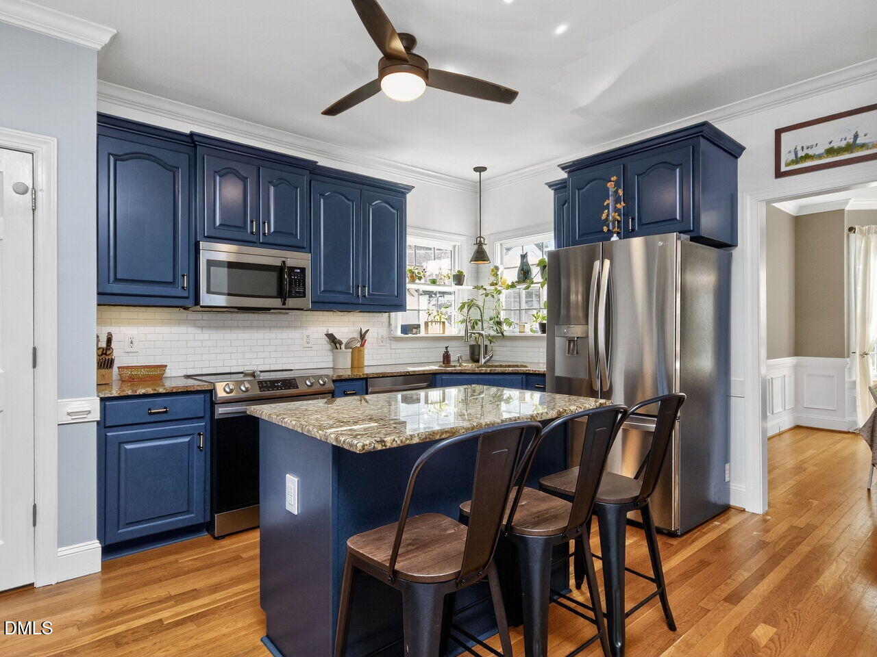 6736 Hammersmith Drive Raleigh, NC 27613 - Photo 10 of 42 a kitchen with stainless steel appliances granite countertop a table chairs refrigerator and microwave
