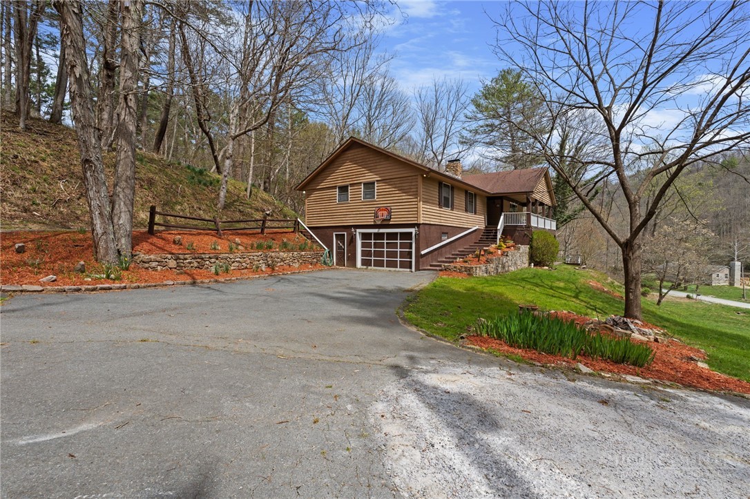 2345 Watauga River Road Sugar Grove, NC 28679 - Photo 36 of 50 a front view of a house with a yard and garage