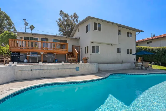 a balcony with furniture and wooden deck