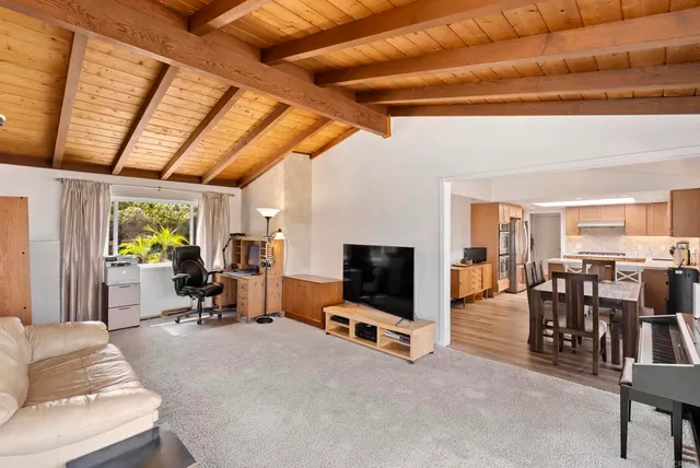 a living room with furniture a window and gym equipment