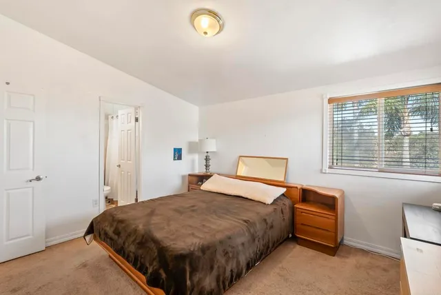 a bedroom with a bed and a desk