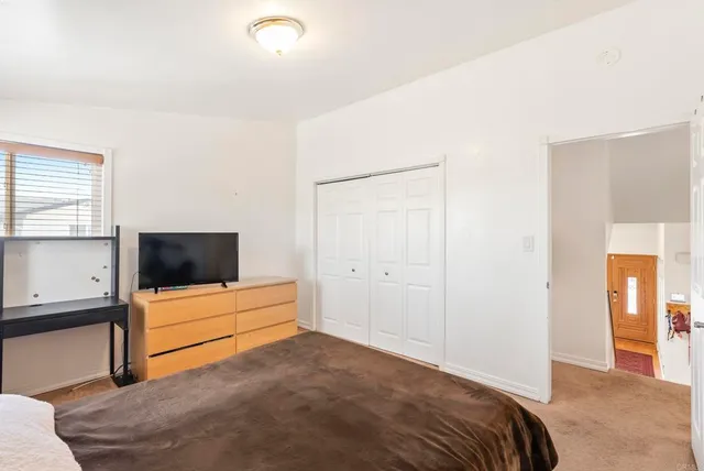 a view of a swimming pool with a yard and palm trees