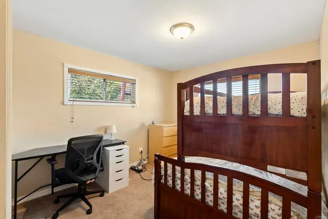 an aerial view of residential house with outdoor space and trees all around