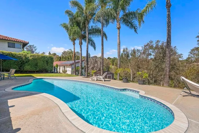 an aerial view of a house with a yard and garden