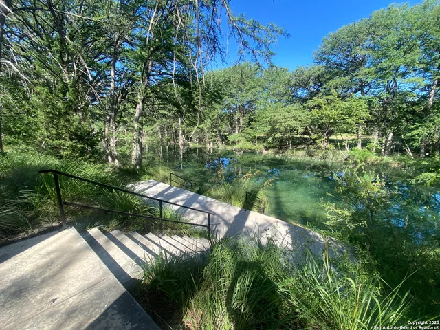 a backyard of a house with a yard and outdoor seating