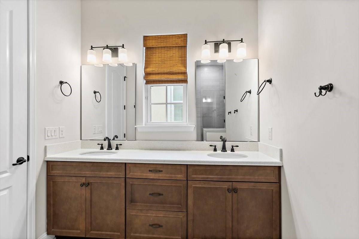 96014 Enclave Manor Fernandina Beach, FL 32034 - Photo 14 of 32 a bathroom with a double vanity sink and mirror