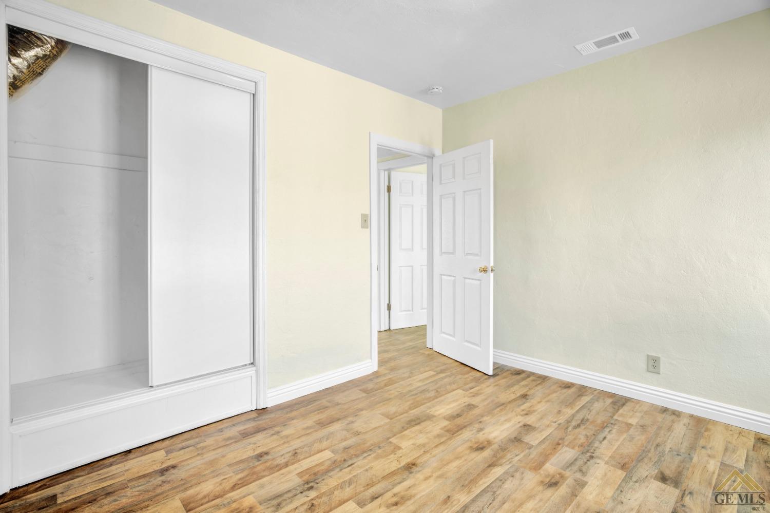 Undisclosed Address Bakersfield, CA 93308 - Photo 14 of 34 a view of a room with wooden floor