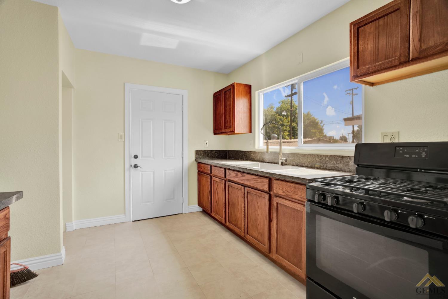 Undisclosed Address Bakersfield, CA 93308 - Photo 15 of 34 a kitchen with stainless steel appliances granite countertop a stove and a sink