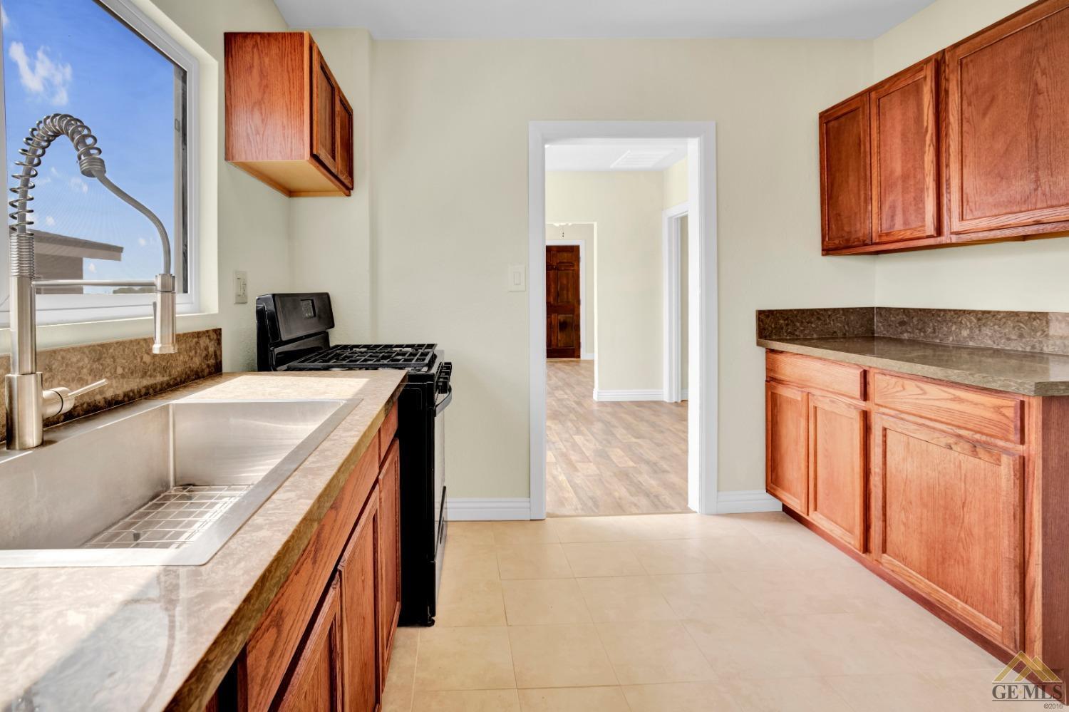 Undisclosed Address Bakersfield, CA 93308 - Photo 16 of 34 a kitchen with stainless steel appliances granite countertop a sink and cabinets