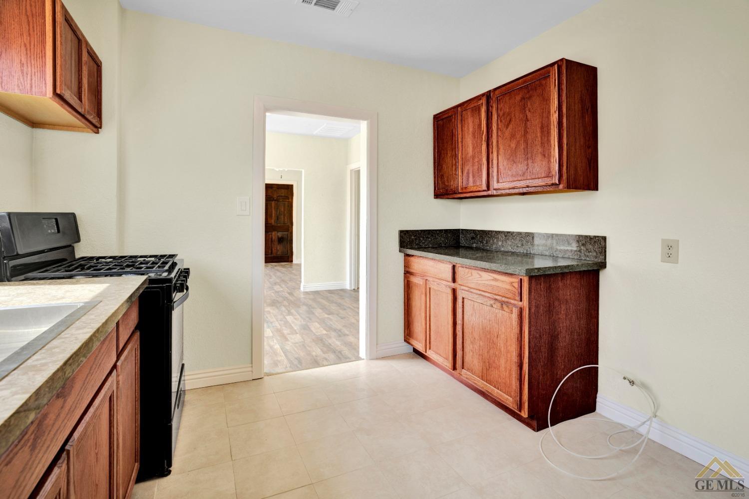 Undisclosed Address Bakersfield, CA 93308 - Photo 17 of 34 a kitchen with stainless steel appliances granite countertop a stove and a microwave