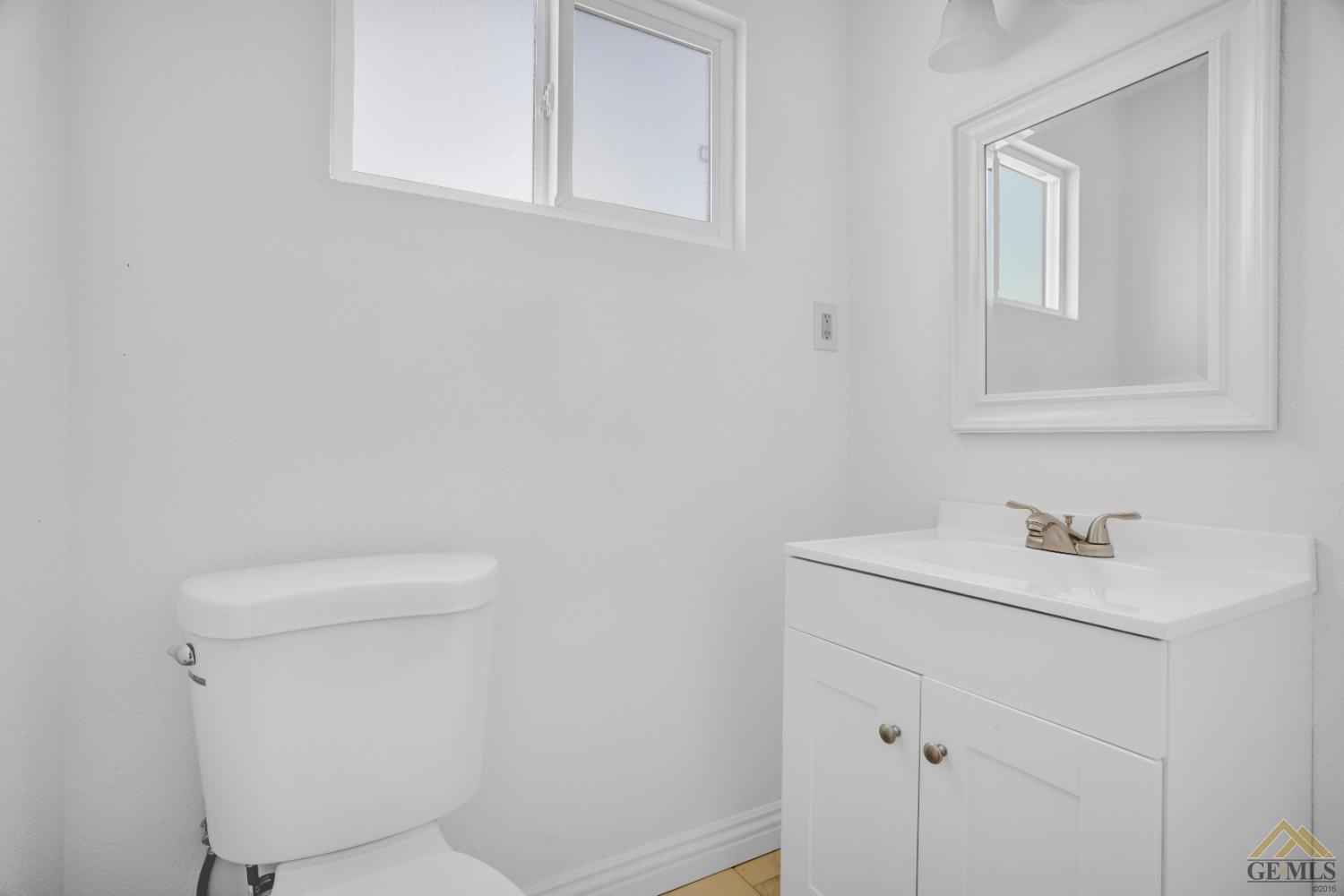 Undisclosed Address Bakersfield, CA 93308 - Photo 20 of 34 a bathroom with a sink a toilet and vanity