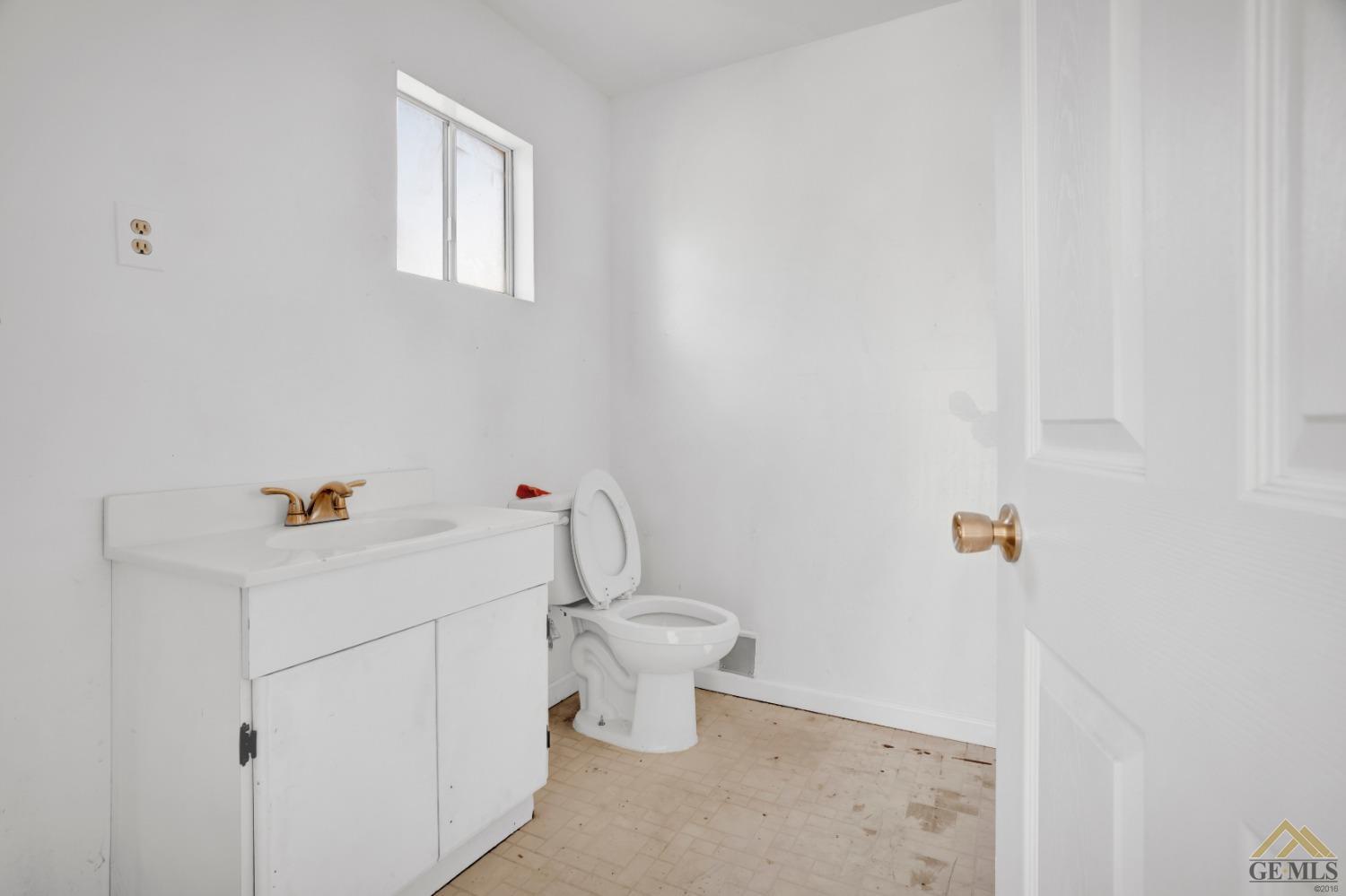 Undisclosed Address Bakersfield, CA 93308 - Photo 26 of 34 a bathroom with a sink a toilet and mirror