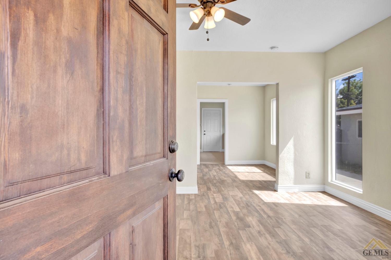 Undisclosed Address Bakersfield, CA 93308 - Photo 3 of 34 a view of hallway with window and wooden floor
