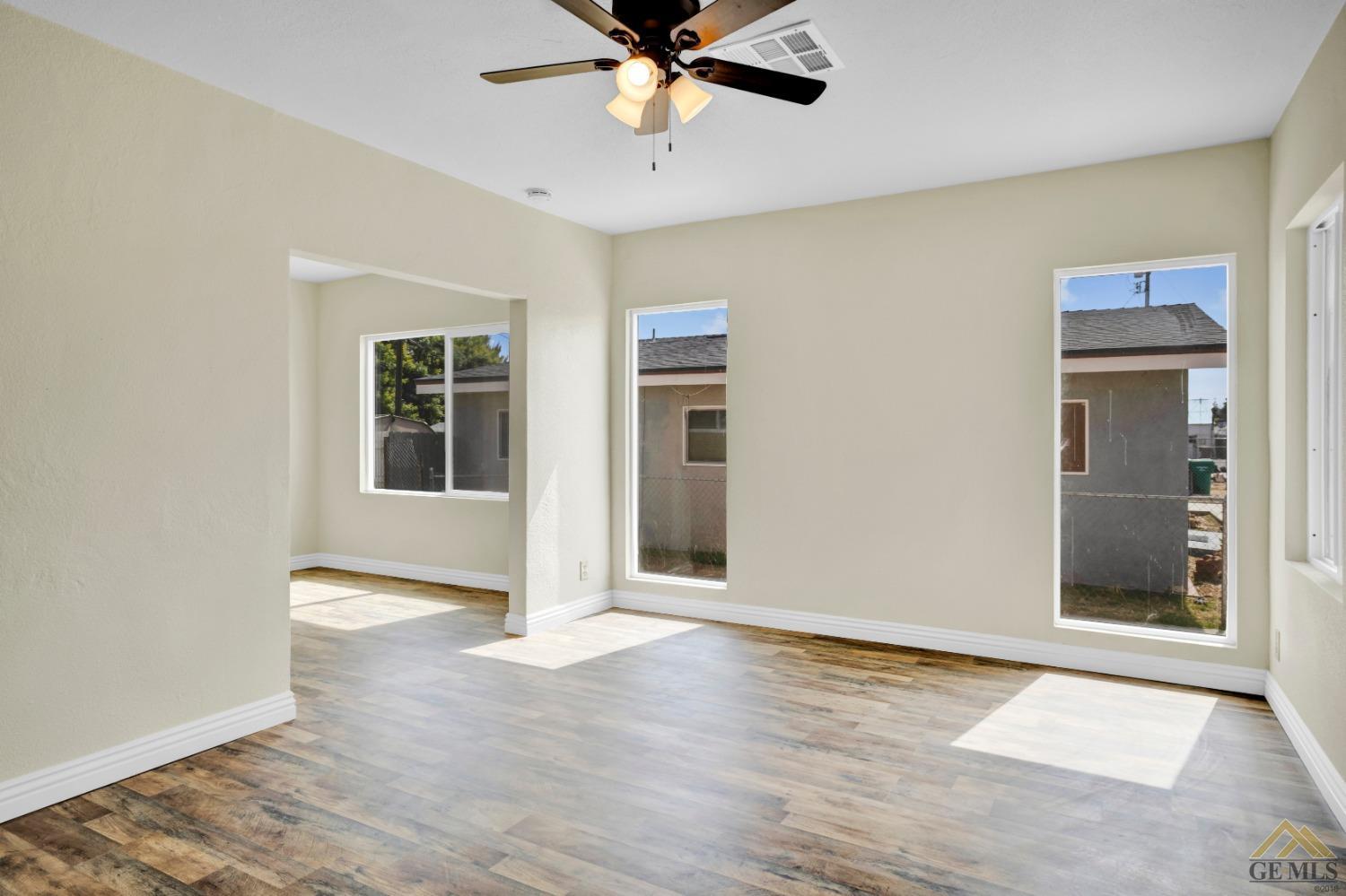 Undisclosed Address Bakersfield, CA 93308 - Photo 4 of 34 a view of an empty room with window and a kitchen