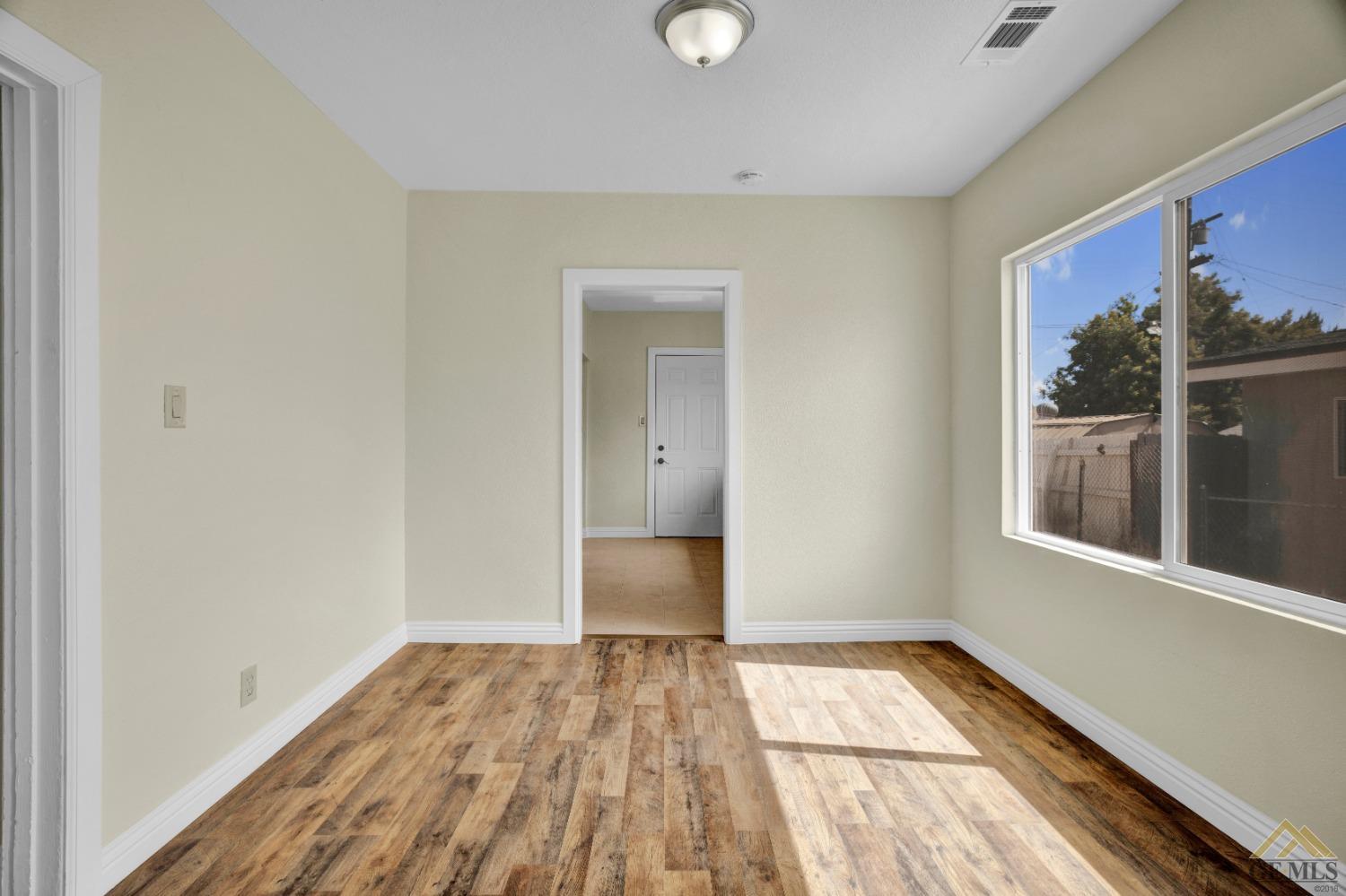 Undisclosed Address Bakersfield, CA 93308 - Photo 7 of 34 a view of a room with wooden floor and a window