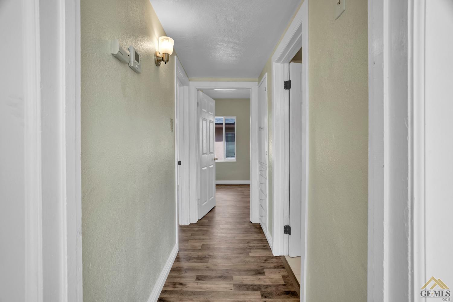 Undisclosed Address Bakersfield, CA 93308 - Photo 8 of 34 a view of a hallway with wooden floor and staircase