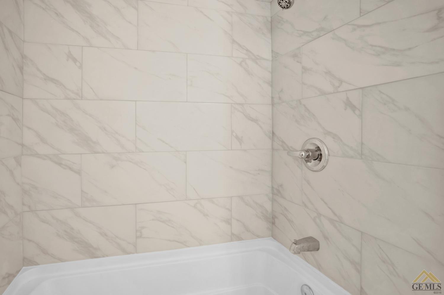 Undisclosed Address Bakersfield, CA 93308 - Photo 10 of 34 a bathroom with a bathtub