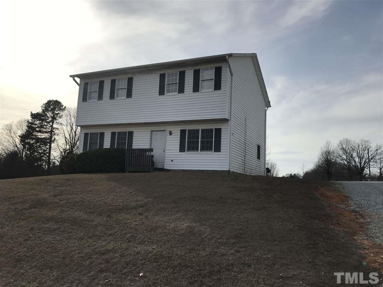 1224 Hurdle Mills Road Roxboro, NC 27573 - Photo 1 of 3 a front view of a house with a yard