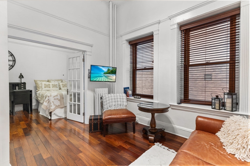 8 Garrison Street, Unit 100 Boston, MA 02116 - Photo 16 of 26 a living room with furniture and a wooden floor