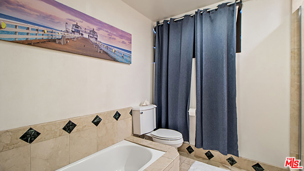 28286 Rey De Copas Lane Malibu, CA 90265 - Photo 11 of 26 a white toilet sitting next to a bathroom sink