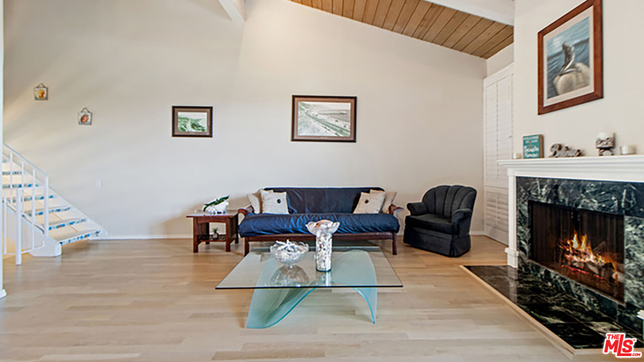 28286 Rey De Copas Lane Malibu, CA 90265 - Photo 2 of 26 a living room with furniture and a fireplace