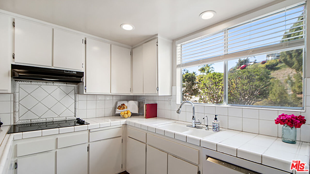 28286 Rey De Copas Lane Malibu, CA 90265 - Photo 5 of 26 a kitchen with a sink cabinets and window